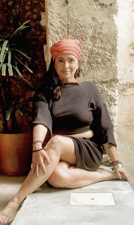 Lori Bellman seated in a mindful pose while traveling
